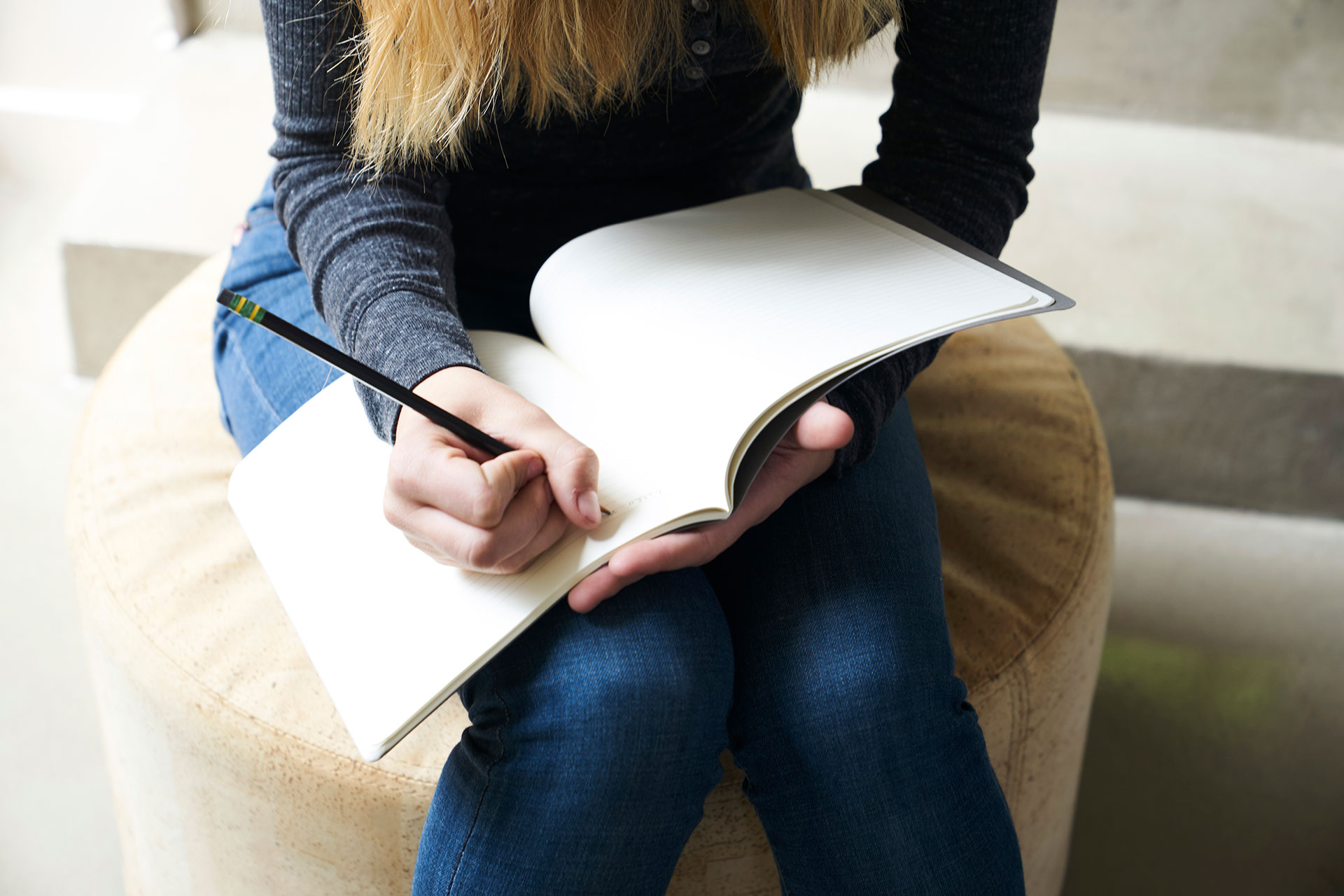 Student working in a notebook brainstorming.